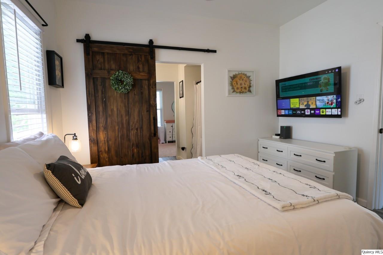 630 South 19th Street Quincy, IL 62301 - Photo 10 of 17 a bedroom with a bed and a flat screen tv