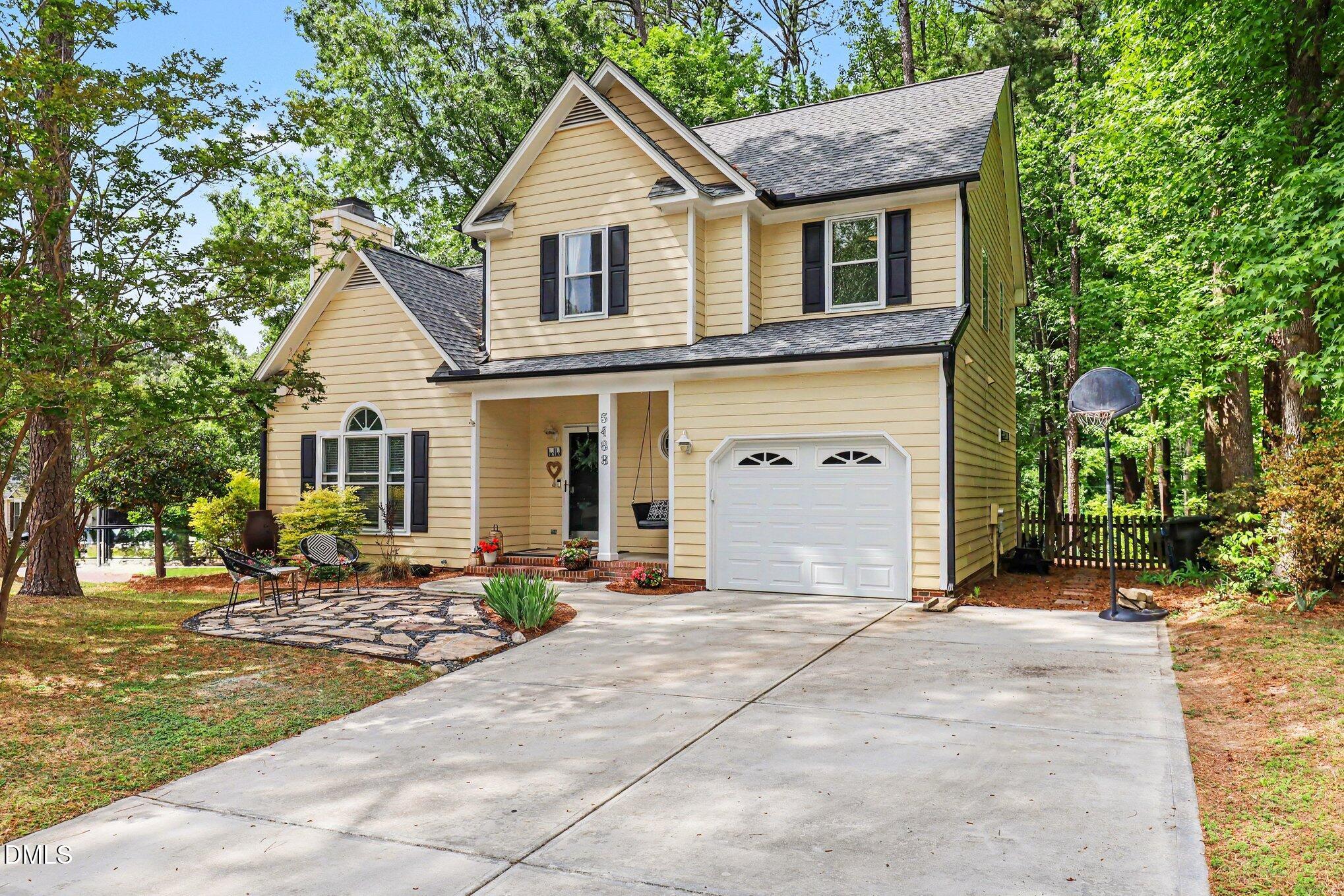 5468 Ingate Way Raleigh, NC 27613 - Photo 1 of 24 a front view of a house with garden