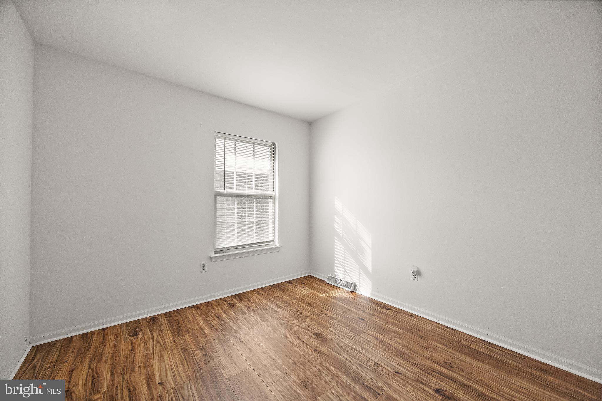78 3 Rivers Drive Newark, DE 19702 - Photo 17 of 27 an empty room with wooden floor and windows