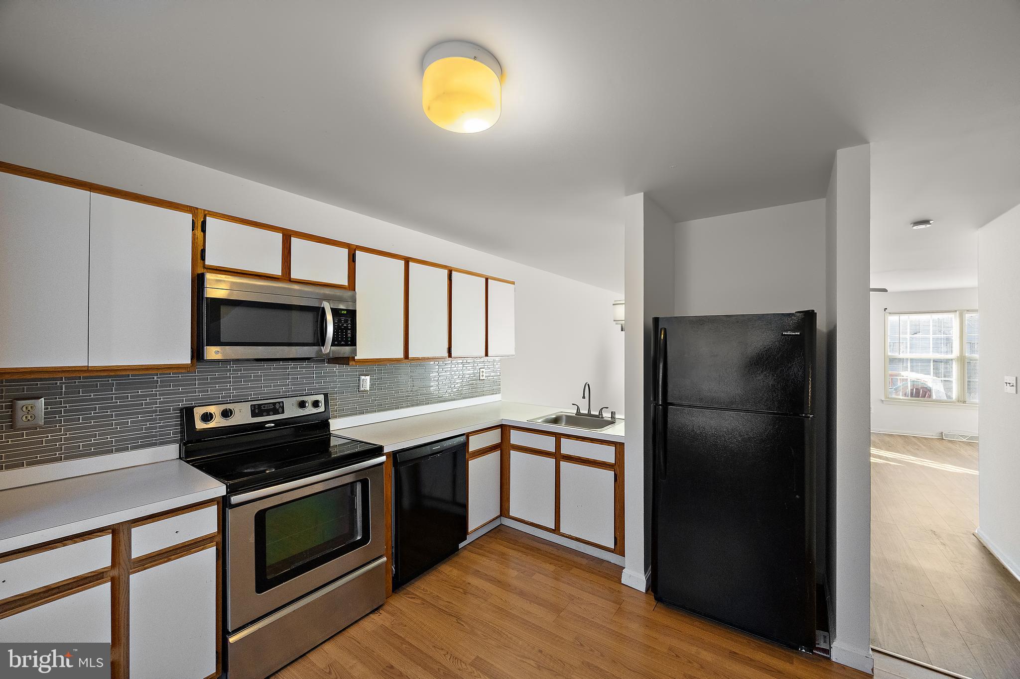 78 3 Rivers Drive Newark, DE 19702 - Photo 3 of 27 a kitchen with a sink a stove and refrigerator