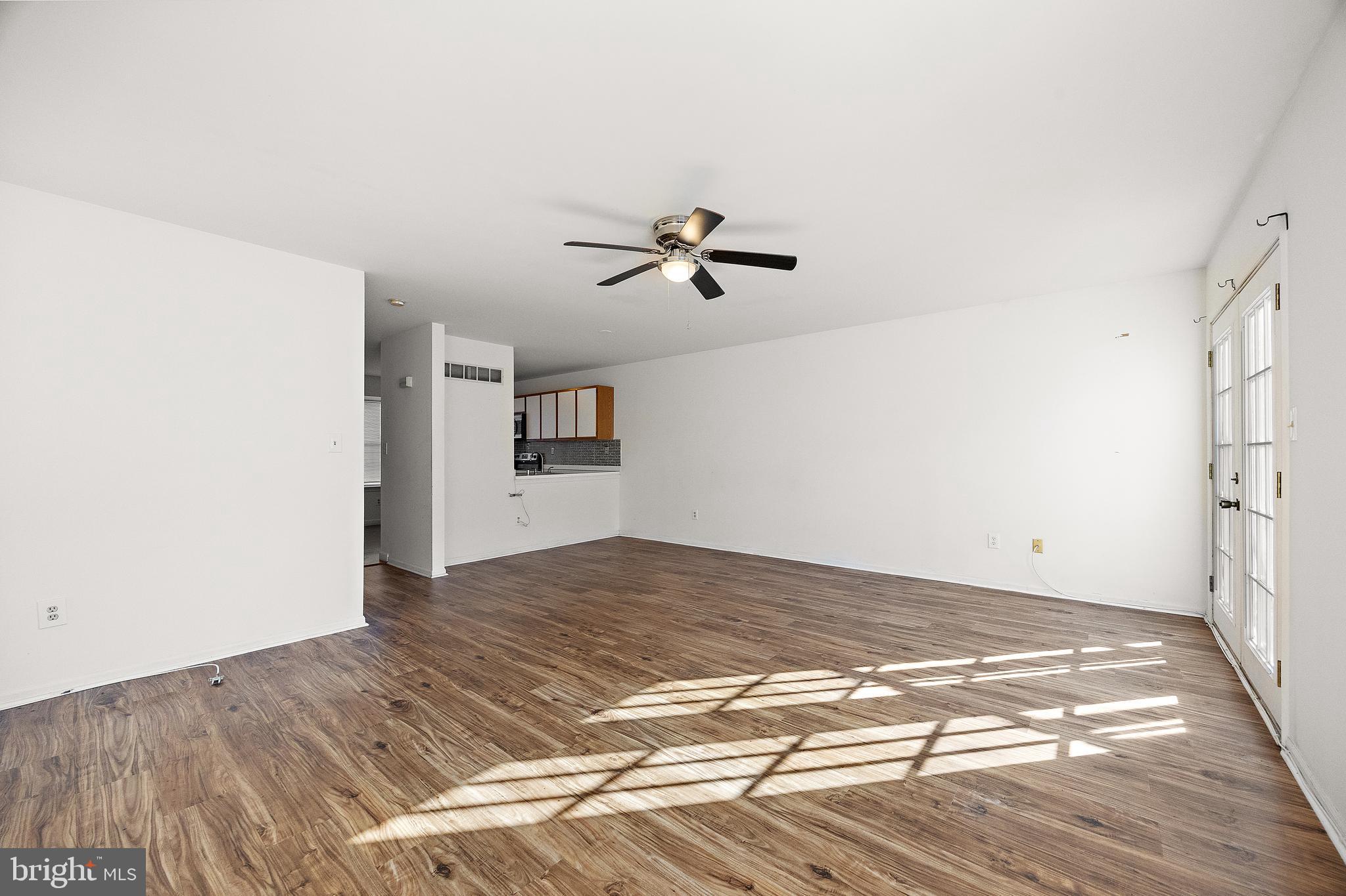 78 3 Rivers Drive Newark, DE 19702 - Photo 7 of 27 a view of a kitchen with wooden floor and a ceiling fan