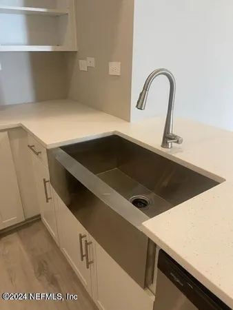 a close view of sink and cabinets
