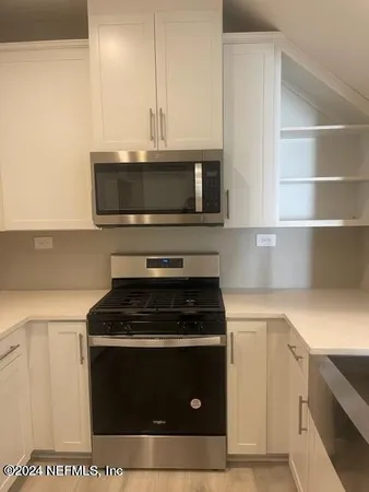 a kitchen with a stove and a microwave