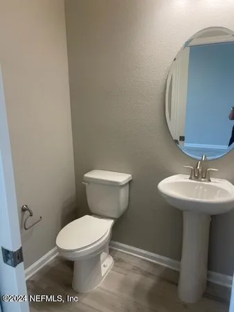 a white toilet sitting next to a bathroom sink