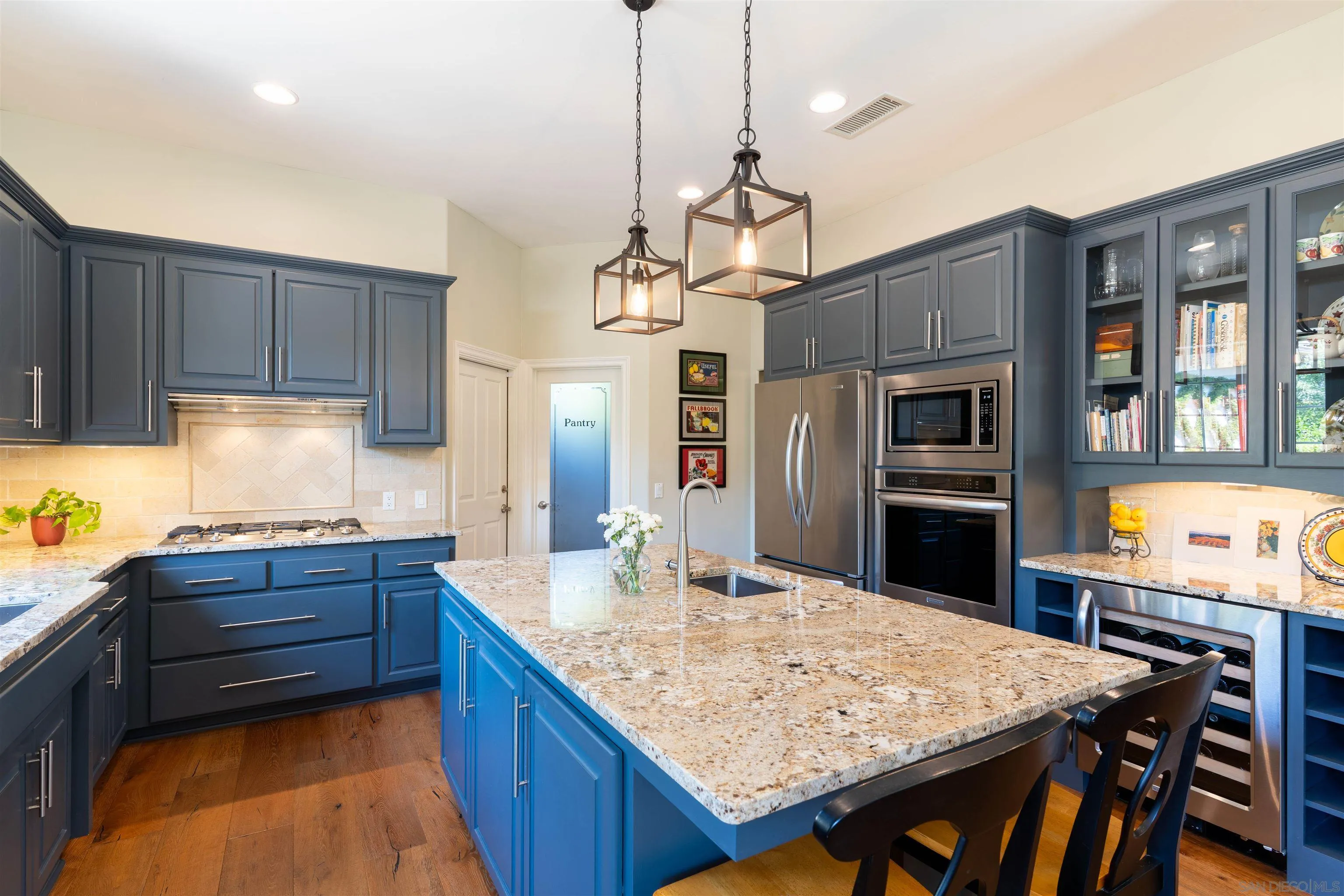 1411 Surrey Heights Fallbrook, CA 92028 - Photo 8 of 33 a kitchen with kitchen island a sink stove and refrigerator