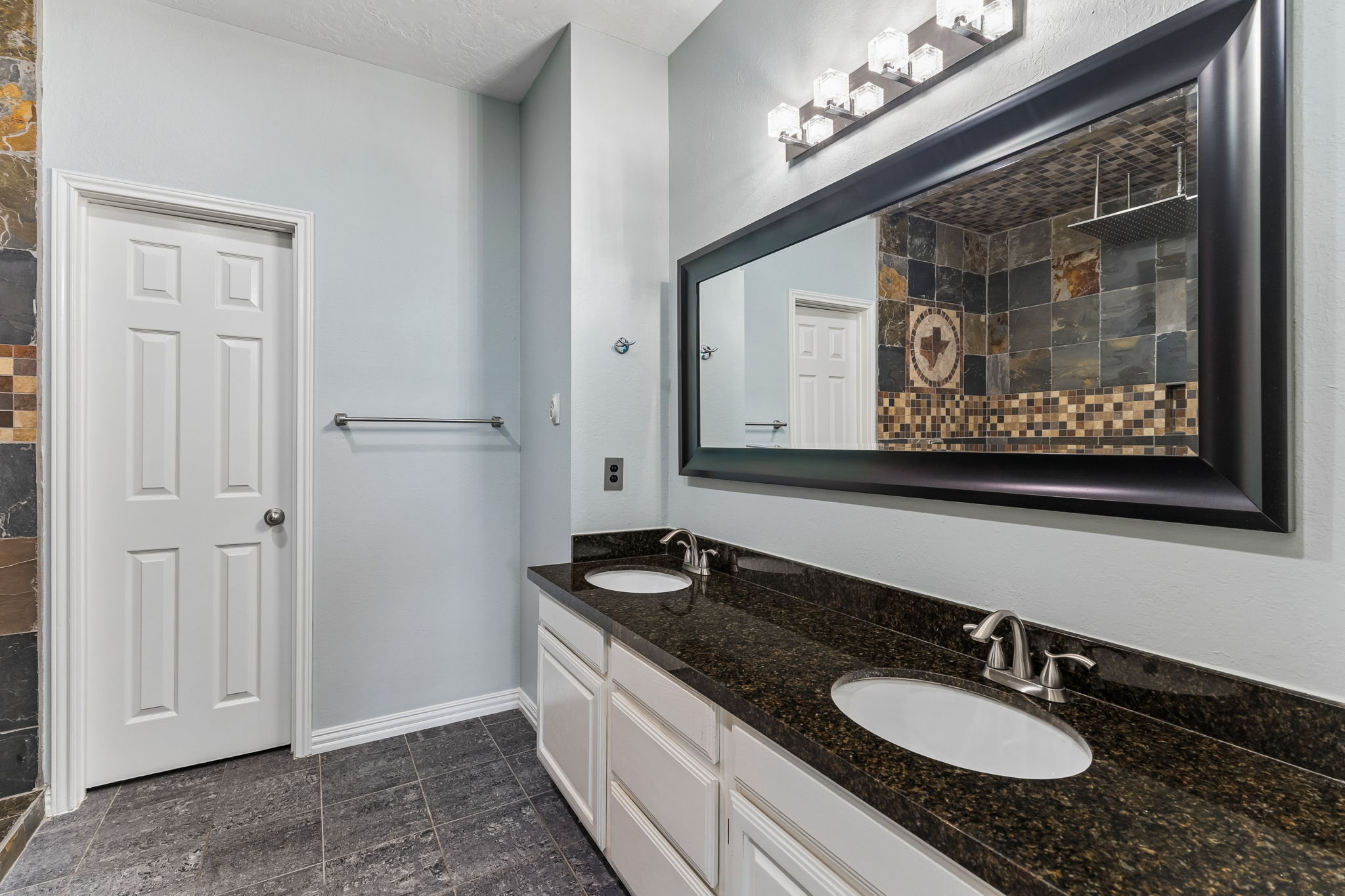 10400 O'Rourk Lane Austin, TX 78739 - Photo 13 of 33 a bathroom with a granite countertop double vanity sink and a mirror
