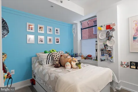 a bedroom with a bed and a wooden floor