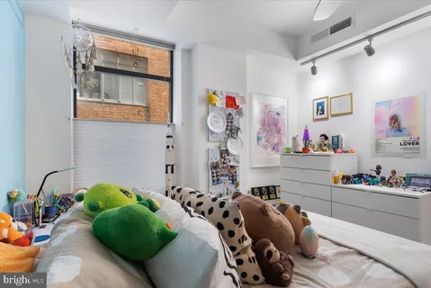 a bedroom with a bed and a table in it