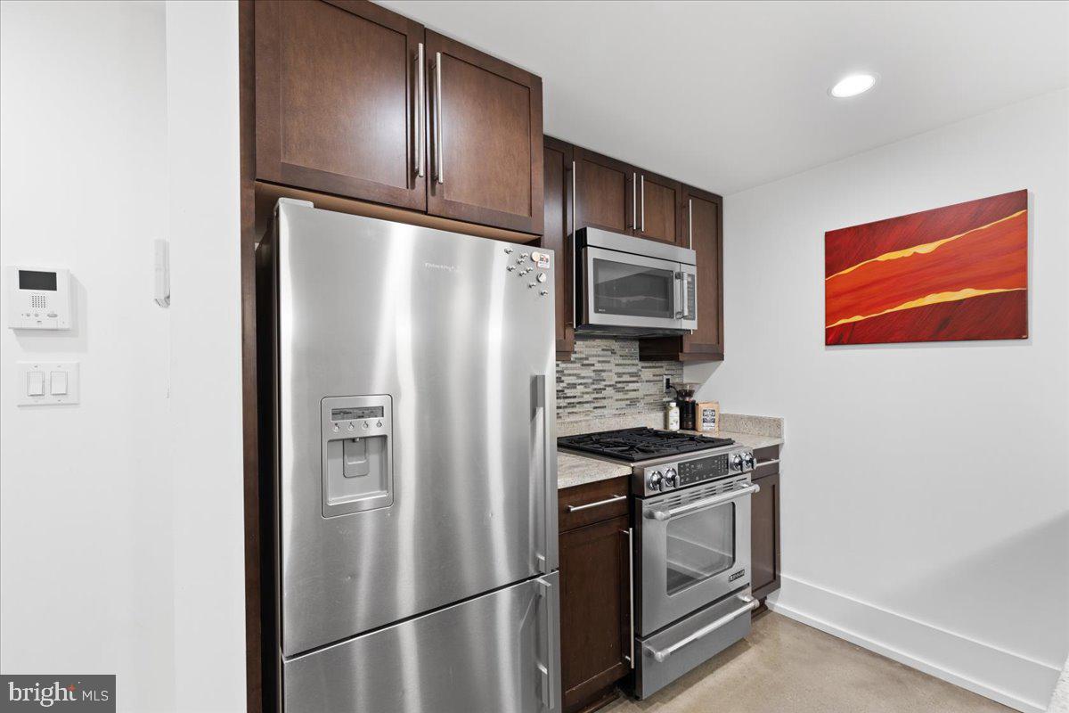 2818 Connecticut Avenue Northwest, Unit 104 Washington, DC 20008 - Photo 9 of 27 a kitchen with stainless steel appliances granite countertop a refrigerator stove and microwave