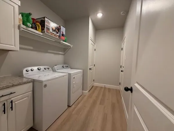 a view of a storage & utility room with a washer dryer