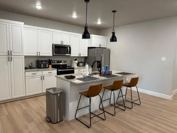 a kitchen with a sink a microwave a stove and refrigerator