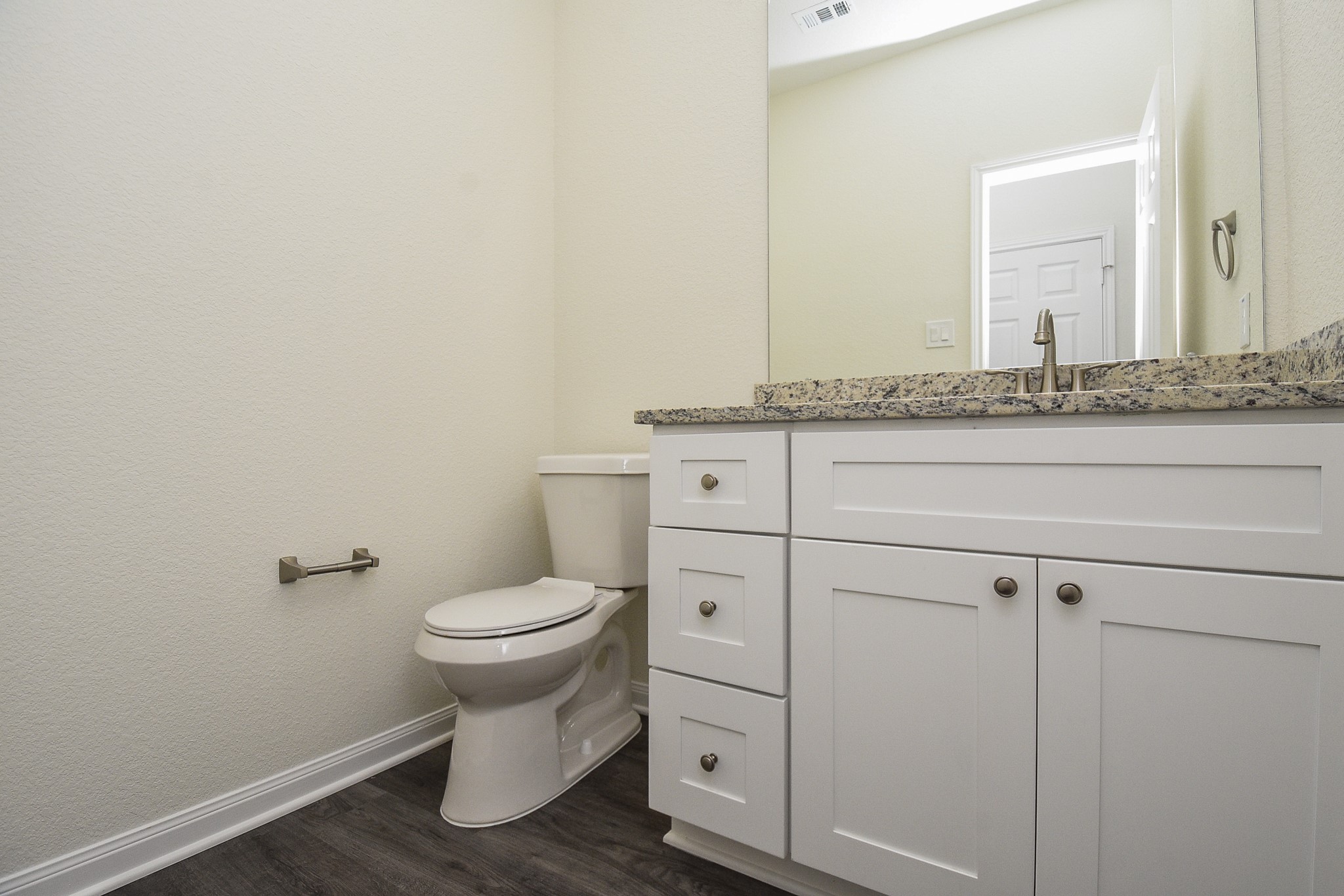 2811 Topiary Lane Houston, TX 77014 - Photo 29 of 32 A clean, modern bathroom with a white vanity, mirrored medicine cabinet, and toilet. Neutral colors and good lighting give it a fresh look.