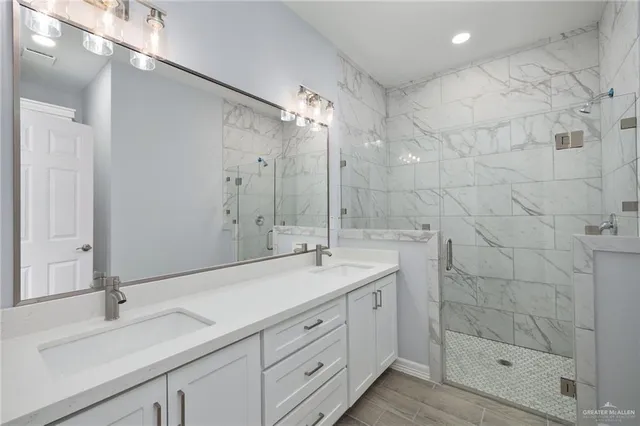 a spacious bathroom with a shower sink and mirror