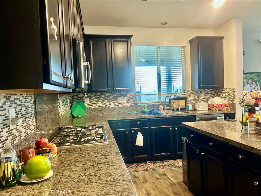31509 Tuberose Road Murrieta, CA 92563 - Photo 11 of 41 a kitchen with a sink and cabinets