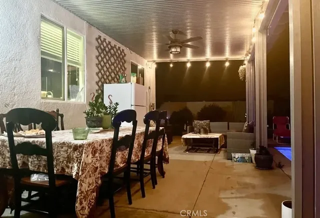 a view of a livingroom with furniture wooden floor and a floor to ceiling window