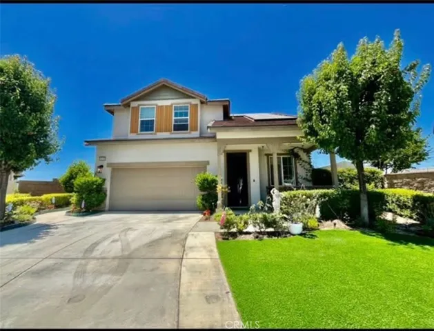 a front view of a house with a yard and porch