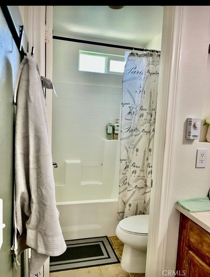 31509 Tuberose Road Murrieta, CA 92563 - Photo 24 of 41 a bathroom with a shower curtain and a toilet