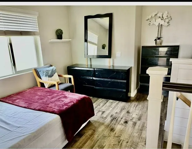 a bedroom with a bed and a mirror