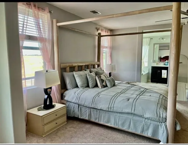 a bedroom with a bed and a window