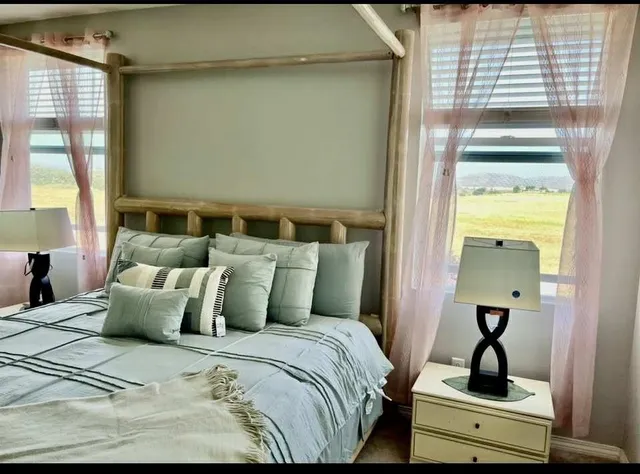 a bathroom with a double vanity sink a tub and a mirror