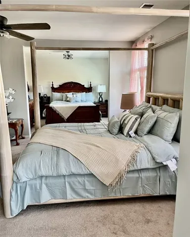 a bedroom with a bed and a mirror