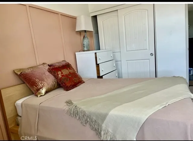 a bedroom with a bed and window