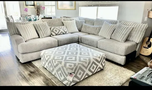 a dining room with furniture potted plants and wooden floor