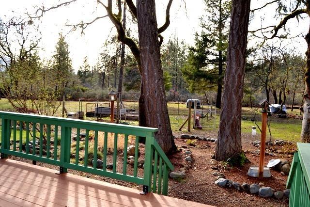 6535 Rockydale Road Cave Junction, OR 97523 - Photo 14 of 35 Side of deck leads down to path to the g