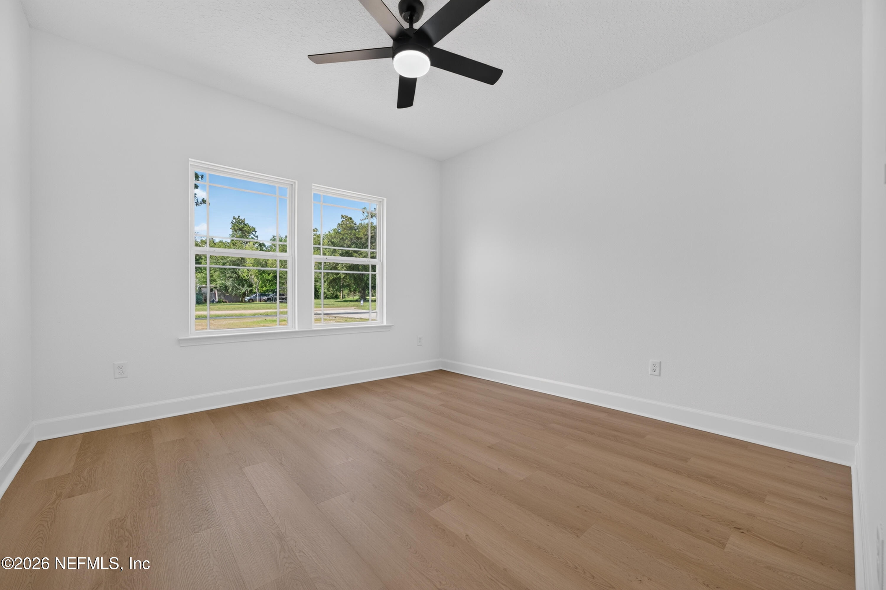 4362 Angora Street Middleburg, FL 32068 - Photo 23 of 31 an empty room with wooden floor ceiling fan and windows
