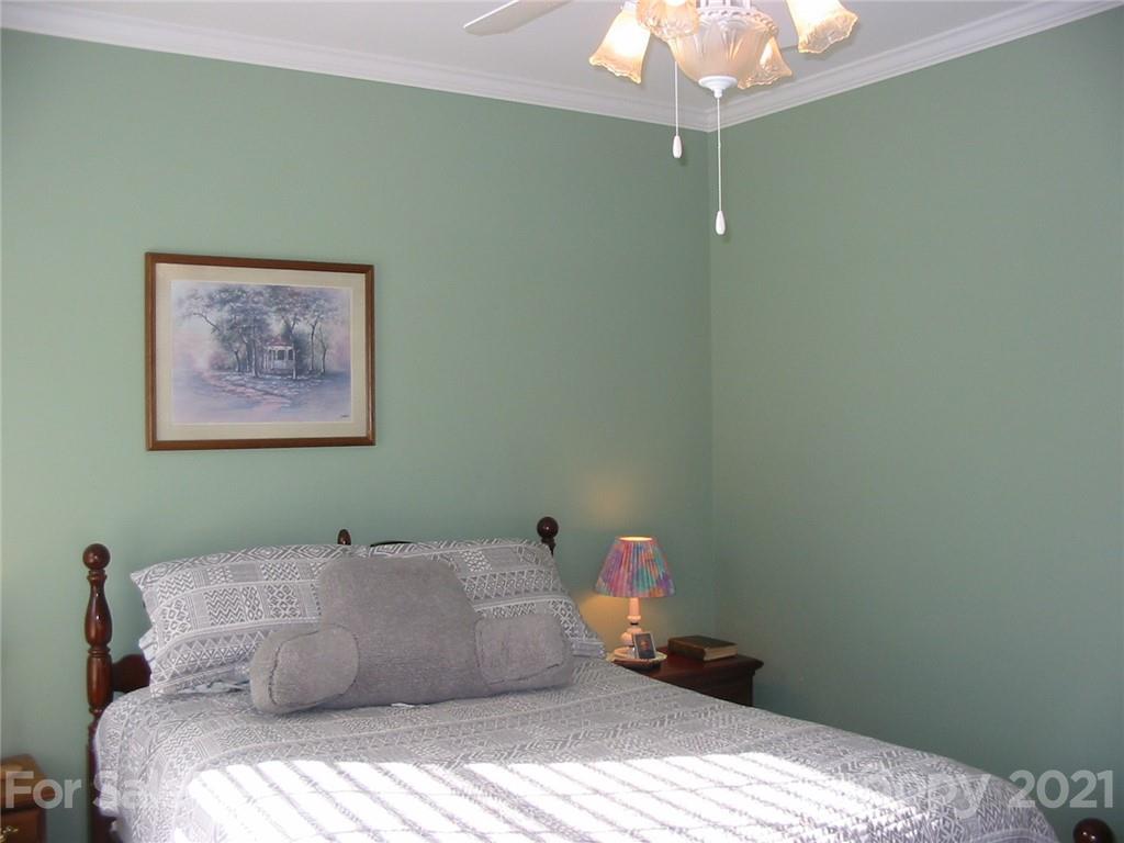 1875 Barringer Road Rock Hill, SC 29730 - Photo 22 of 30 a bedroom with a bed and a chandelier