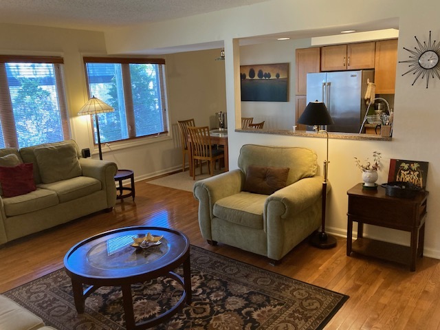 1154 Inverrary Lane, Unit 1154 Deerfield, IL 60015 - Photo 4 of 19 a living room with furniture and a fireplace