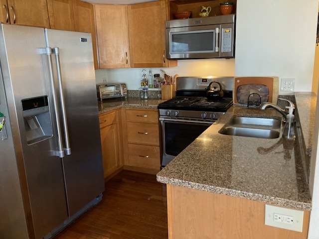 1154 Inverrary Lane, Unit 1154 Deerfield, IL 60015 - Photo 7 of 19 a kitchen with granite countertop a refrigerator stove and sink