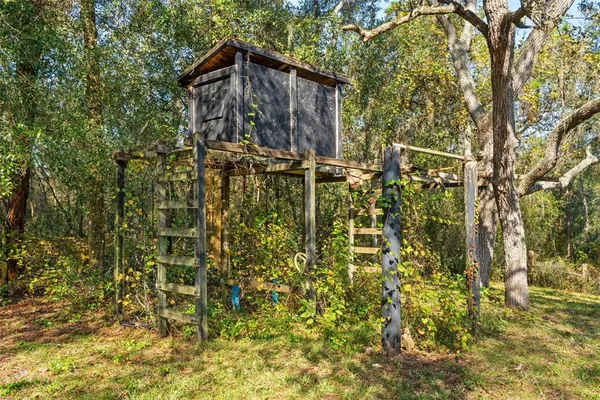 a kitchen with sink a stove and wooden cabinets