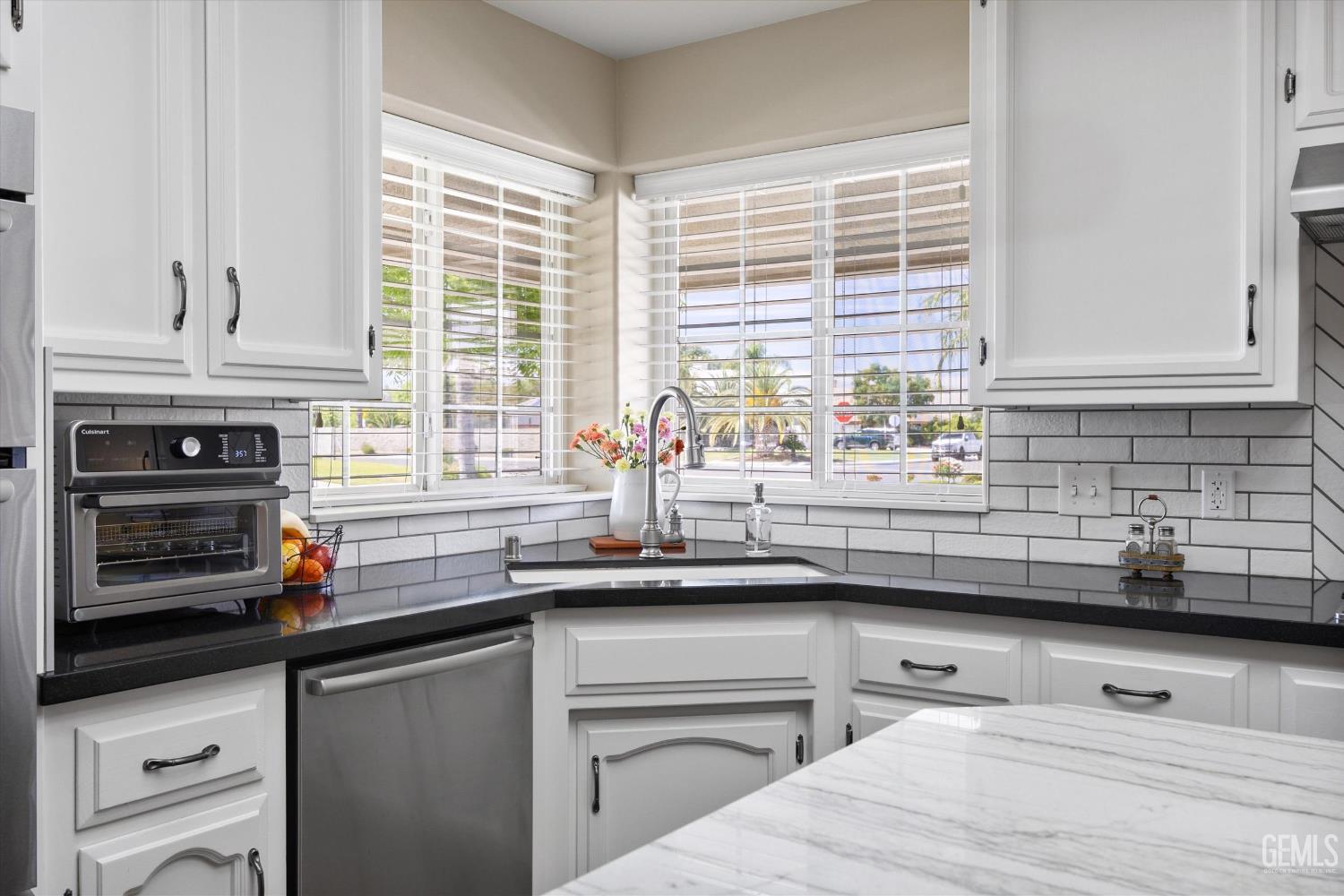 Undisclosed Address Bakersfield, CA 93314 - Photo 23 of 58 a kitchen with stainless steel appliances a sink a stove and a window
