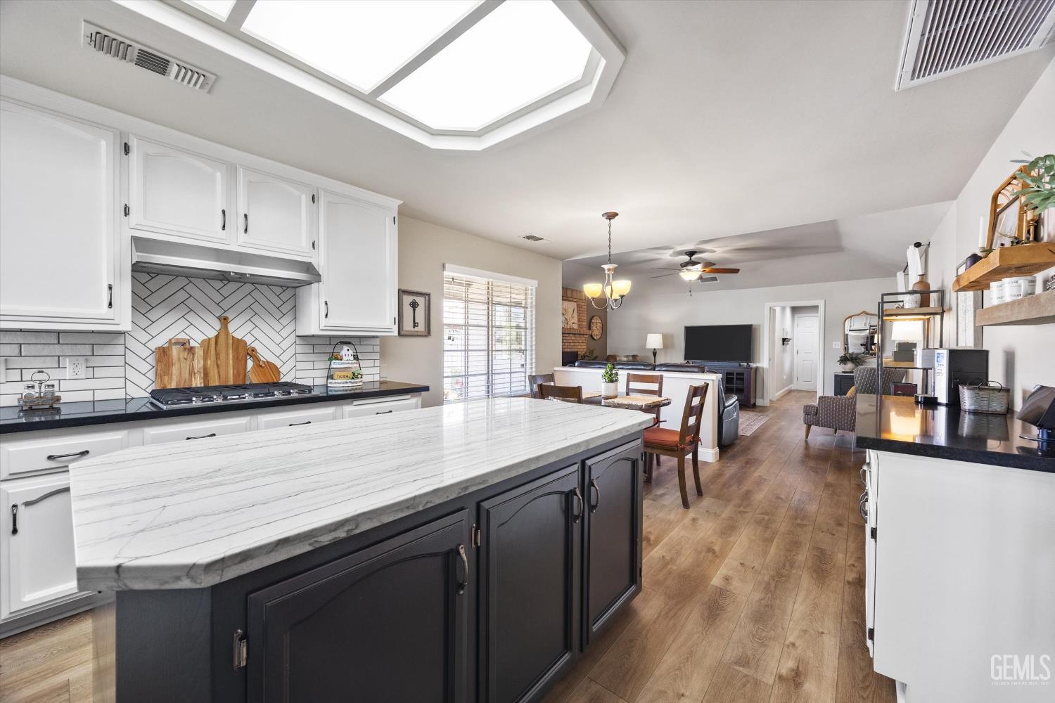 Undisclosed Address Bakersfield, CA 93314 - Photo 24 of 58 a kitchen with lots of counter top space and painting on the wall