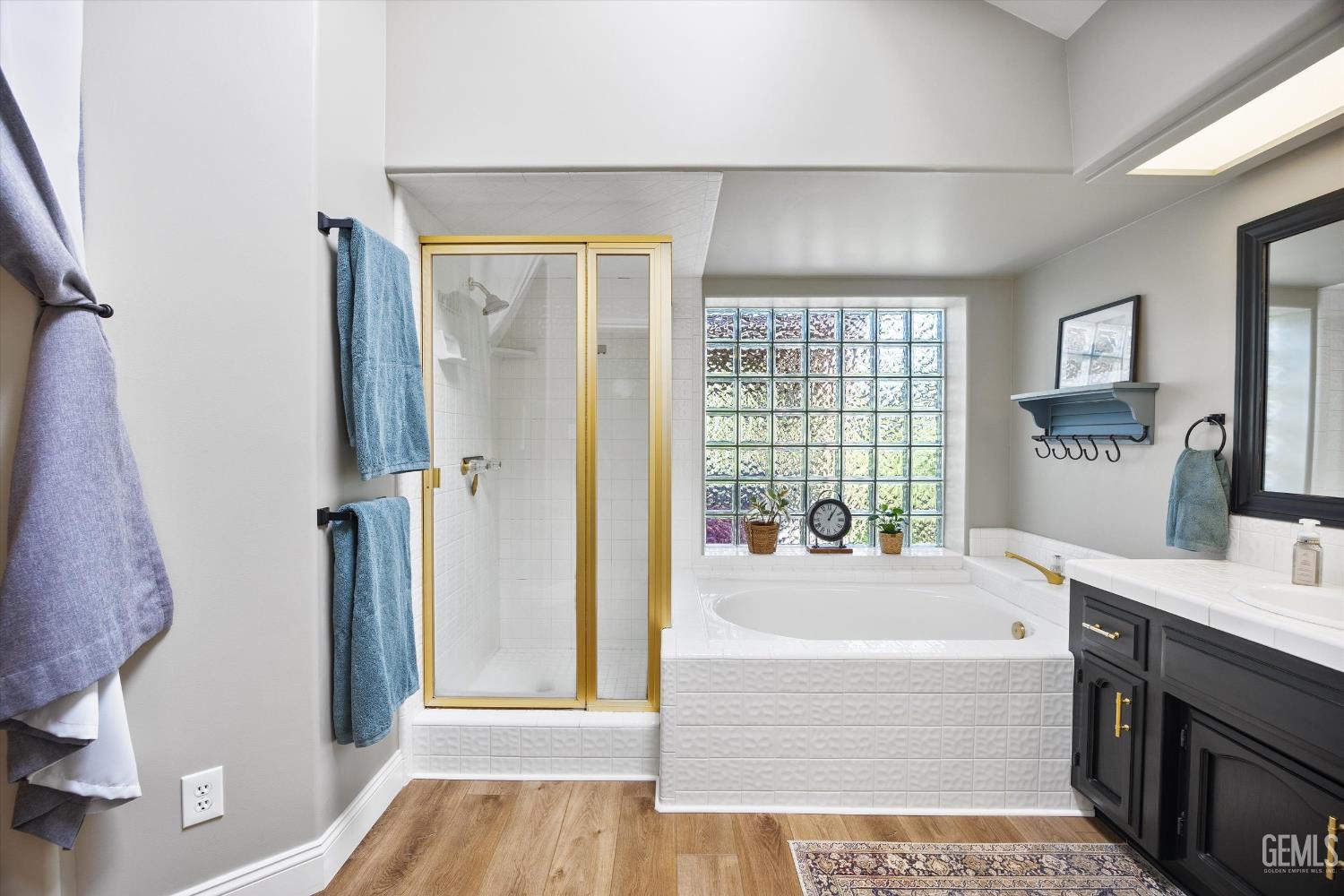 Undisclosed Address Bakersfield, CA 93314 - Photo 28 of 58 a spacious bathroom with a tub shower and a sink