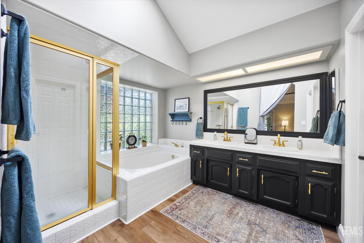 Undisclosed Address Bakersfield, CA 93314 - Photo 29 of 58 a spacious bathroom with a tub sink shower and mirror