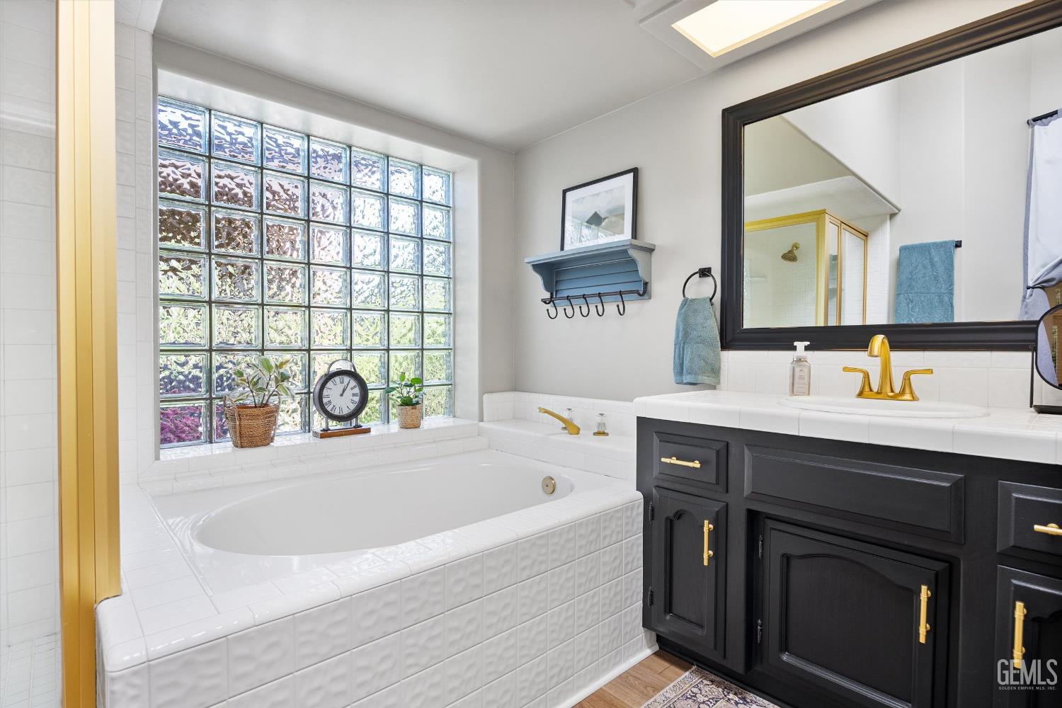 Undisclosed Address Bakersfield, CA 93314 - Photo 30 of 58 a bathroom with a sink and a bathtub