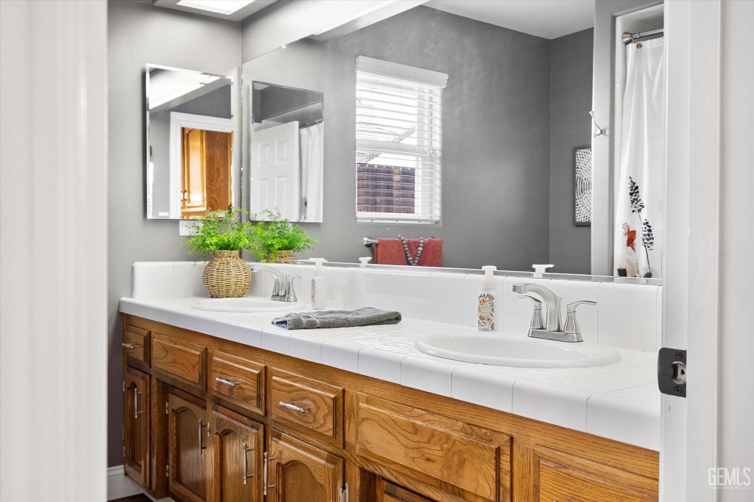 Undisclosed Address Bakersfield, CA 93314 - Photo 32 of 58 a bathroom with a sink and a mirror