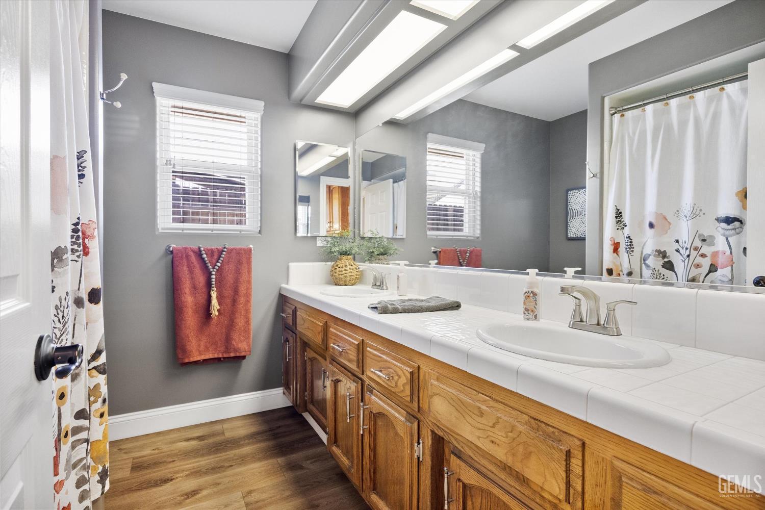 Undisclosed Address Bakersfield, CA 93314 - Photo 33 of 58 a bathroom with double vanity sink a mirror and a shower