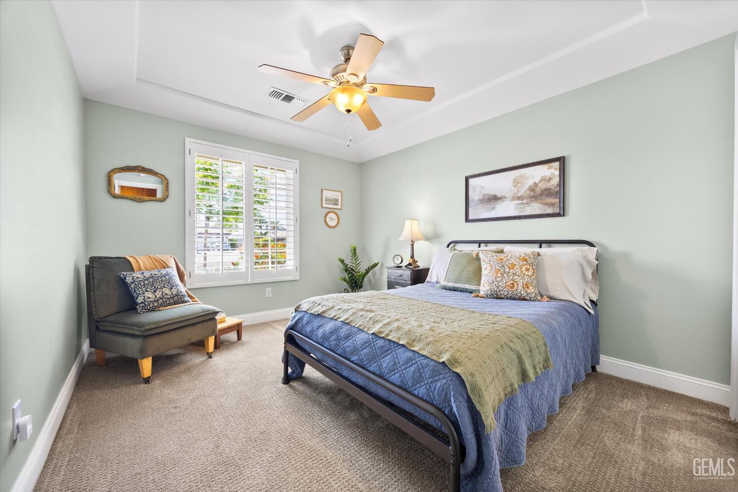 Undisclosed Address Bakersfield, CA 93314 - Photo 35 of 58 a spacious bedroom with a bed and a chandelier