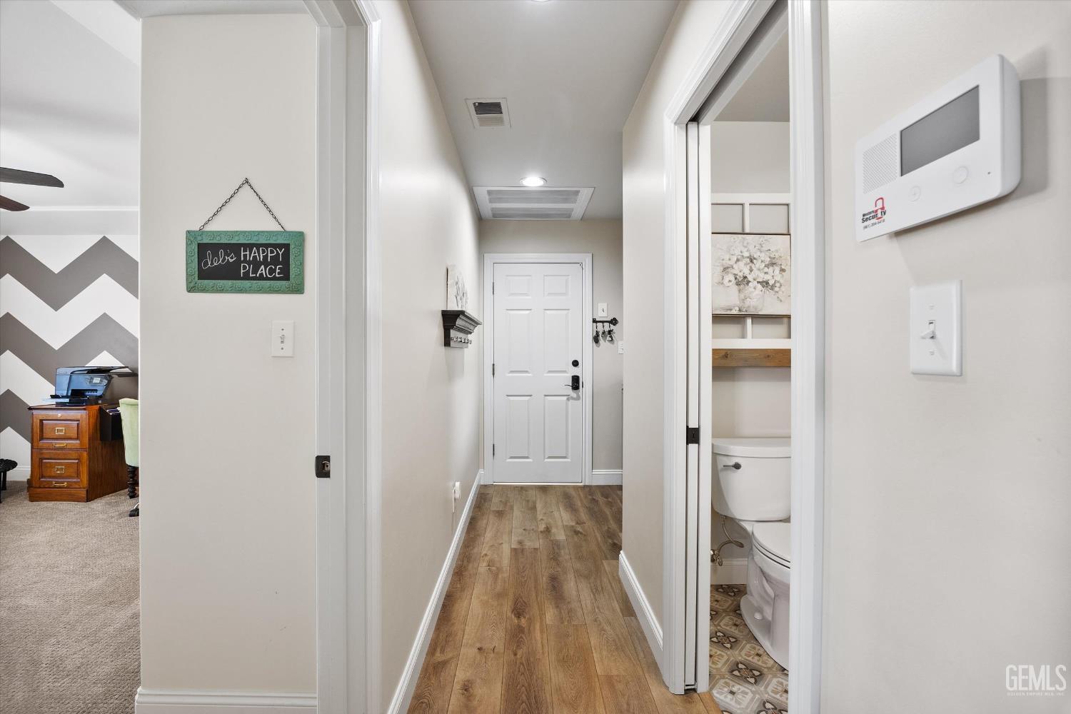 Undisclosed Address Bakersfield, CA 93314 - Photo 40 of 58 a view of a hallway with wooden floor and staircase