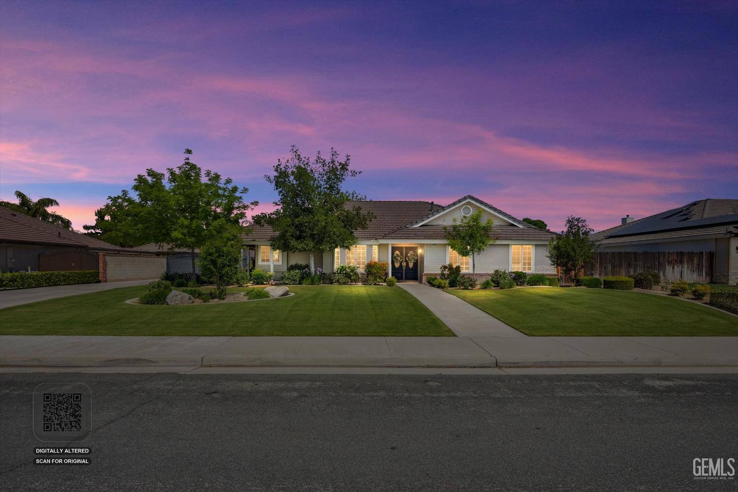 Undisclosed Address Bakersfield, CA 93314 - Photo 4 of 58 a front view of a house with a yard and a garage