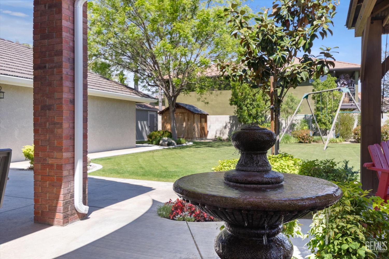 Undisclosed Address Bakersfield, CA 93314 - Photo 46 of 58 a view of a fountain in the yard next to a building
