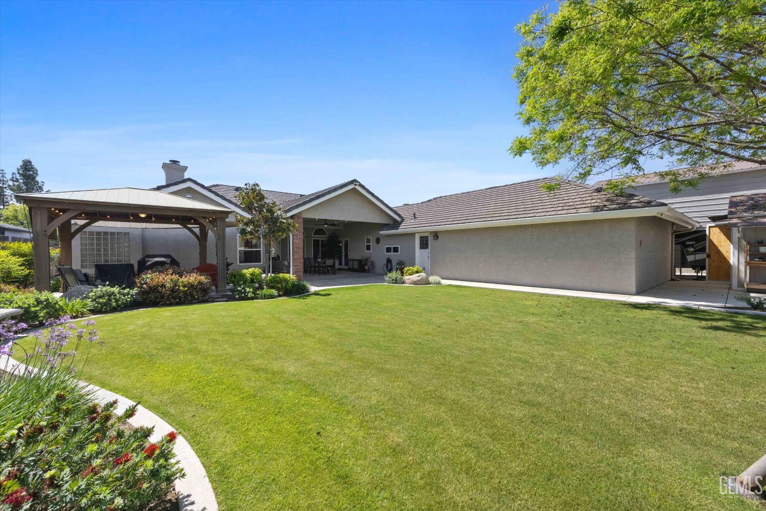 Undisclosed Address Bakersfield, CA 93314 - Photo 50 of 58 a front view of a house with garden