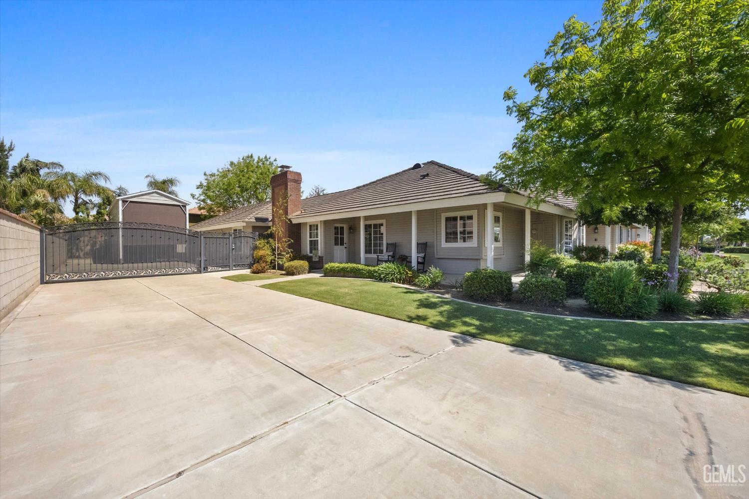 Undisclosed Address Bakersfield, CA 93314 - Photo 54 of 58 a front view of a house with a yard and potted plants