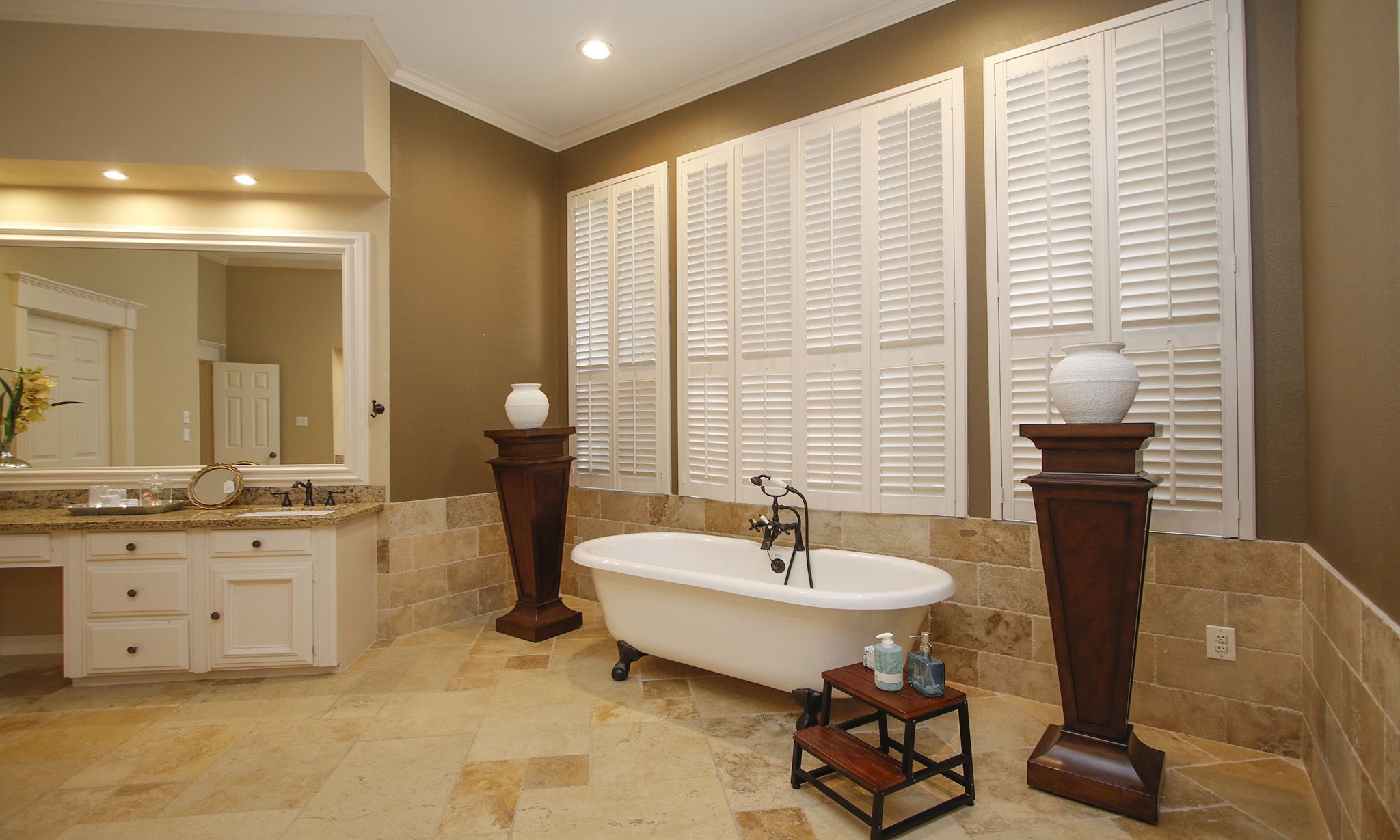 15923 Harwick Drive Spring, TX 77379 - Photo 17 of 50 The primary bathroom has a bear claw tub framed with windows adorned with plantation shutters.