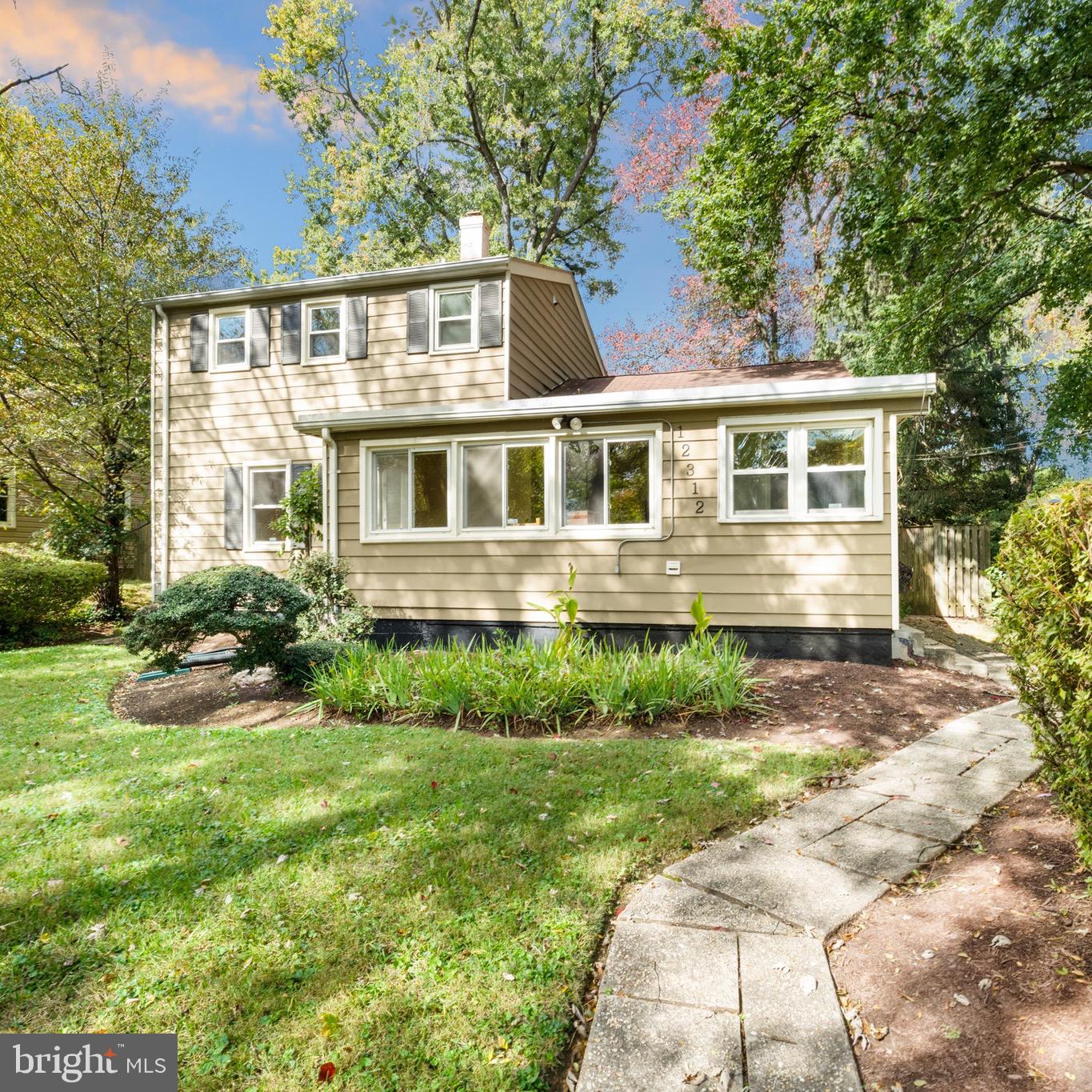 12312 Valleywood Drive Silver Spring, MD 20902 - Photo 1 of 65 a front view of a house with garden