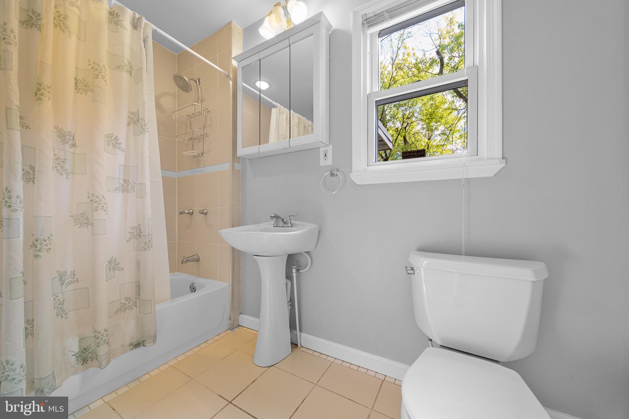 12312 Valleywood Drive Silver Spring, MD 20902 - Photo 23 of 65 a bathroom with a sink toilet and shower