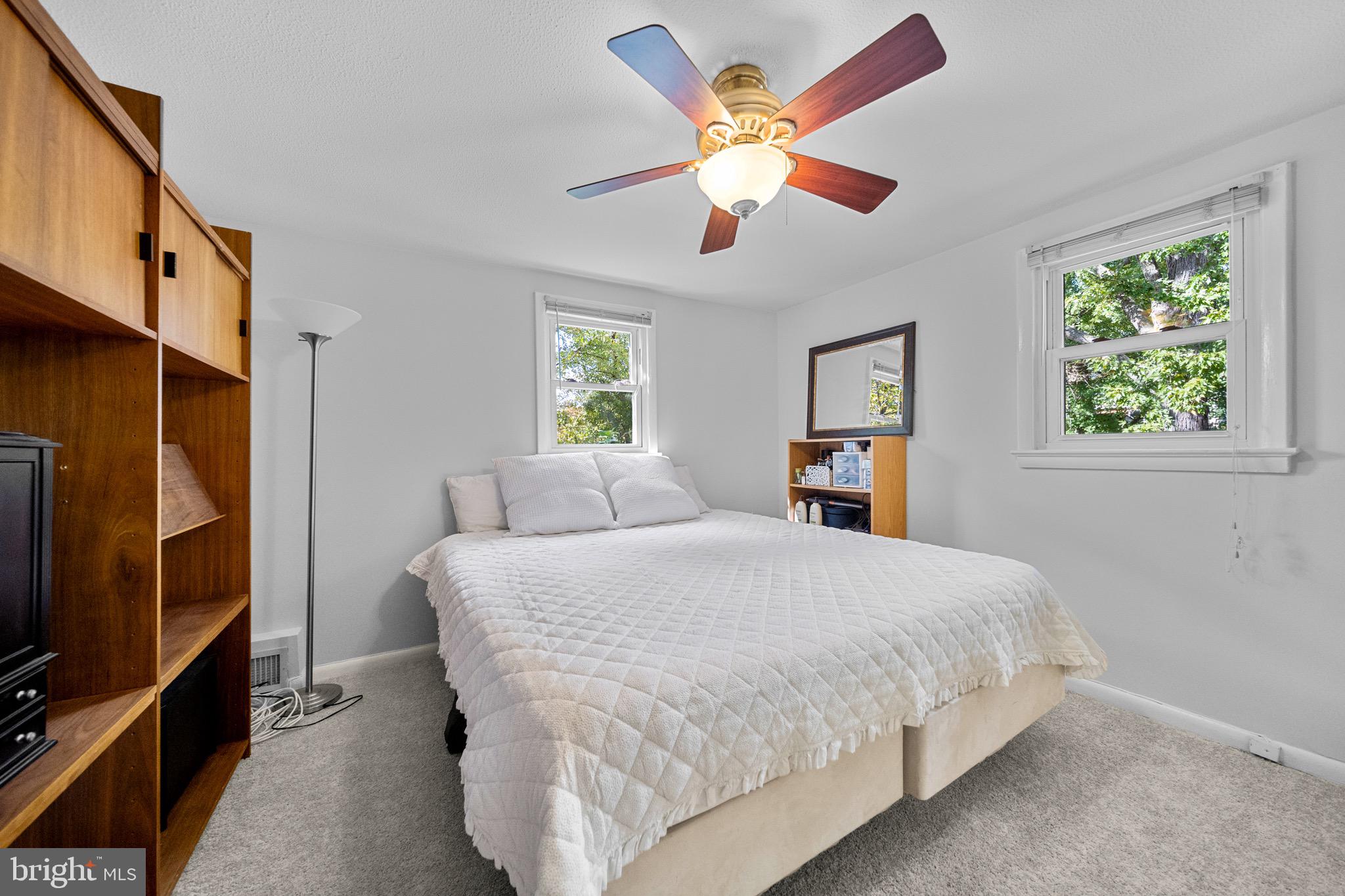 12312 Valleywood Drive Silver Spring, MD 20902 - Photo 33 of 65 a bedroom with a large bed a chandelier and dresser